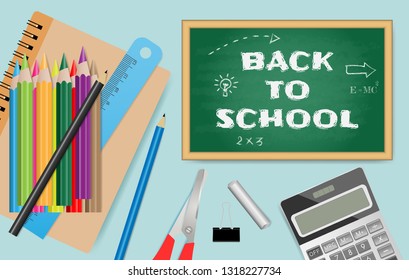 Back to school text on chalkboard with school supplies on green background