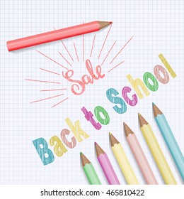 Back to school text on checkered notebook background.