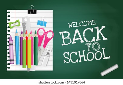 Back to school text on green chalkboard with alarm clock, crayon, notepaper, pencil, chalk, scissors, ruler, sharpener and paperclip. Education concept