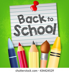 Back to School Text on Pinned Piece of Paper with School Supplies on Green Background
