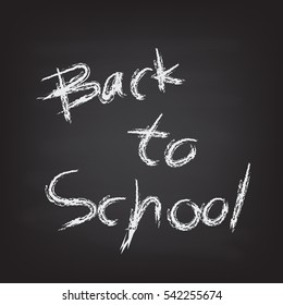Back to school wording by hand writing with chalk on black board. 