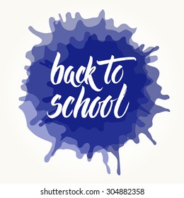 Back to school words hand written by brush, white over blue ink blots.