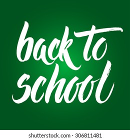 Back to school words hand written by brush, white over green.