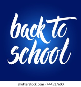 Back to school words hand written by brush, white over dark blue.
