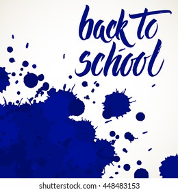 Back to school words hand written by brush, white over blue ink blots.