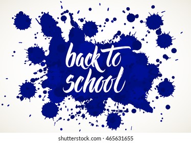 Back to school words hand written by brush, white over blue ink blots.
