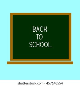Back to school, written on blackboard with chalk on a light green background