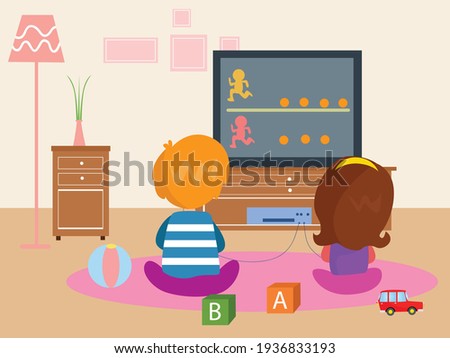 Back view of children playing video game together in the living room at home