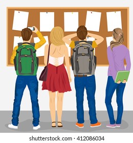 back view of college students looking at bulletin board