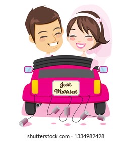 Back view of happy just married couple riding on pink car with cans attached enjoying wedding day