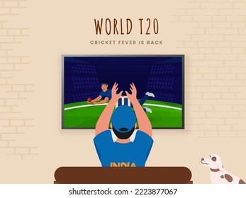 Back View Of India Supporter Man Watching World T20 Cricket Match In LCD Screen On Beige Brick Wall Background.