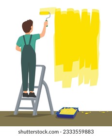 Back view man painting on the wall with paint roller