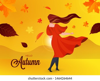 Back view of young woman with flying leaves on beautiful nature background for Hello Autumn poster or banner design.