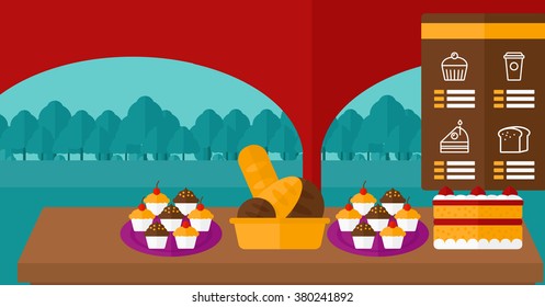 Background of bakery with table full of bread and pastries.