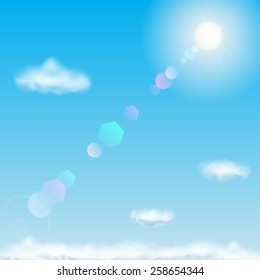 Background with blue sky, sun, lens flare and clouds