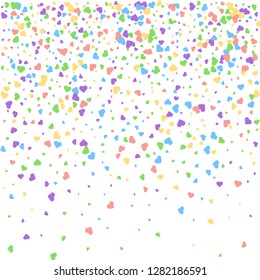 Background from bright multi-colored confetti. Festive confetti in the form of hearts. Joyful confetti on a white background.