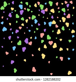 Background from bright multi-colored confetti. Festive confetti in the form of hearts. Joyful confetti on a black background.