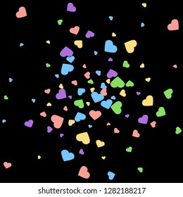 Background from bright multi-colored confetti. Festive confetti in the form of hearts. Joyful confetti on a black background.