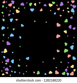 Background from bright multi-colored confetti. Festive confetti in the form of hearts. Joyful confetti on a black background.