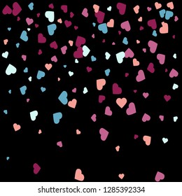 Background from bright multi-colored confetti. Festive confetti in the form of hearts. Joyful confetti on a black background.