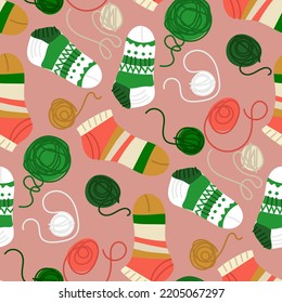 Background with bright multicolored socks on a pink background. Socks with tangles from which they were knitted. Suitable for printed products on paper and textiles. Flyers, banners, clothes.