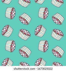 Background with cupcakes. Seamless colorful pattern of glazed cupcakes on a green background. Vector 8 EPS.