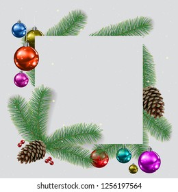 A Ð¡hristmas background with fir branches and decorationson gray