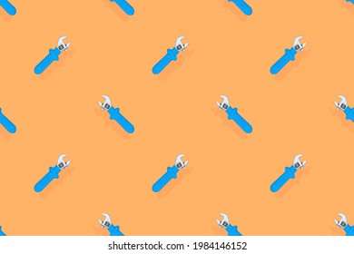 Background from a metal adjustable wrench with a rubber handle. Tools seamless pattern.