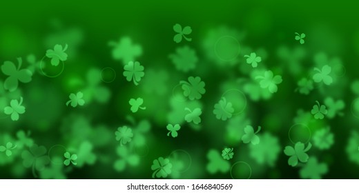 Background on St. Patrick's Day made of blurry clover leaves in green colors with seamless horizontal repetition