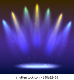 Background with rays of light from the colored spotlights. Bright lighting with coloring spotlights, projector. Shined scene, illumination effects on dark backdrop.