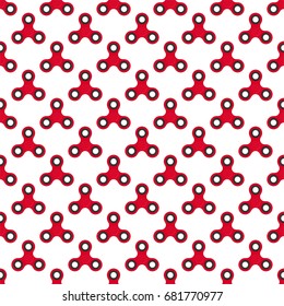 Background from red children fidget spinners on white background. Playing backdrop of hand twisting toys with bearings in a row next to each other and alternately under him 