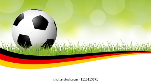 background with soccer ball lying in the grass with german colors banner