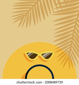 background sun hat with yellow sunglasses on the beach