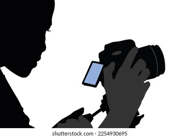 Backlit silhouette of a female photographer isolated on a white background for composites. She is holding a camera and posing as a journalist or a hobbyist