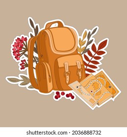 backpack with autumn leaves and map