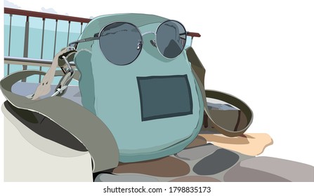 A backpack with glasses placed by the sea ready to travel.