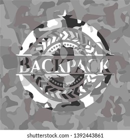 Backpack on grey camouflaged texture