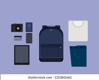 backpack with white t-shirt, pants, camera, credit card, smart phone, tablet and passport ready for travel