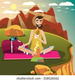 Backpacker sits on a grassland in the mountains near the edge of the cliff, eats sandwich and drinks hot beverage