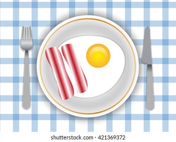 bacon and eggs on a plate and table with blue tablecloth