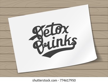 Badge Detox Drinks with Hand Drawn Lettering on A4 Sheet Paper on Wooden Background. Green Emblem Vector Illustration.
