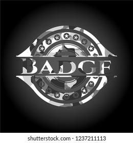 Badge written on a grey camouflage texture