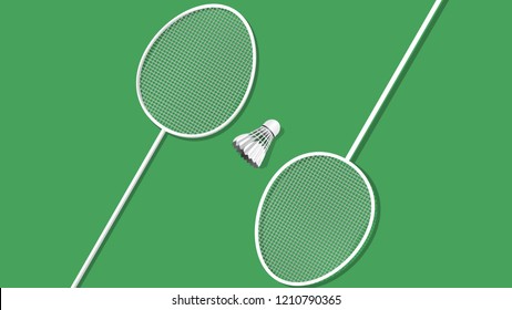 Badminton racket and shuttlecock isolated on green