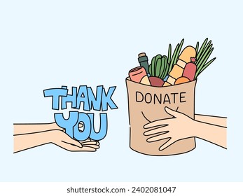 Bag of food in hands of man near inscription thank you, for concept of charity and helping people in need. Metaphor for fight against hunger and provision of food stamps to citizens left without work