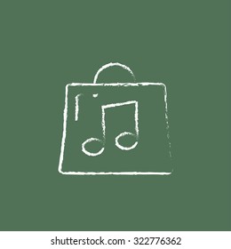 Bag with music note hand drawn in chalk on a blackboard vector white icon isolated on a green background.