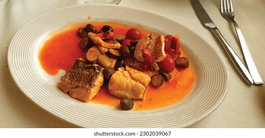 Baked Fish with vegetables in white plate