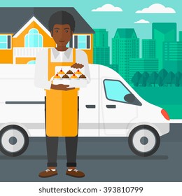 Baker holding box of cakes.