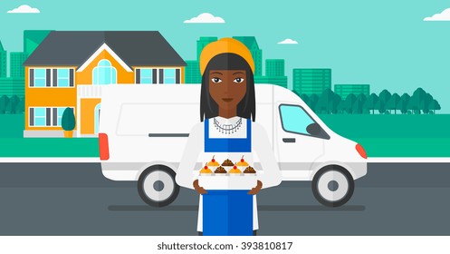 Baker holding box of cakes.