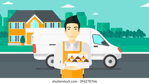 Baker holding box of cakes.