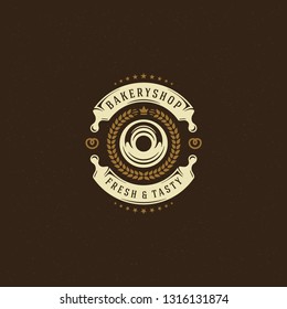 Bakery badge or label retro vector illustration. Rolling pins and donut silhouettes for bakehouse. Typographic logo design.